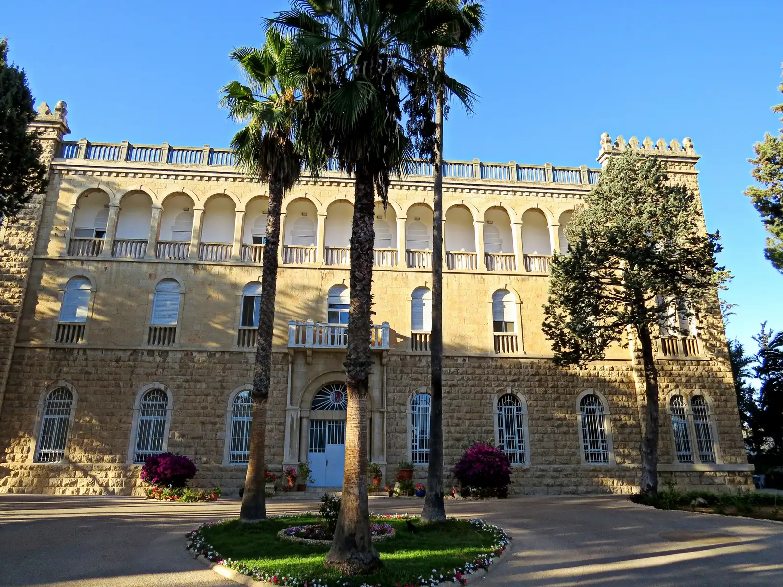 The stone building of the Institute, with its arcaded upper floor and corner towers