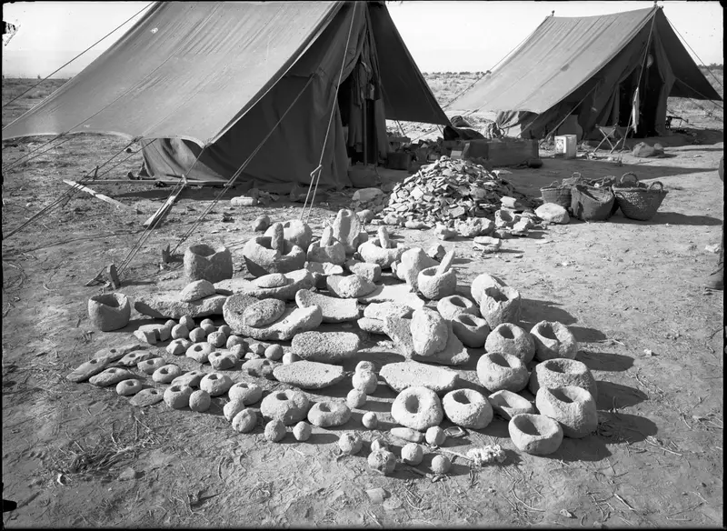 Stone objects from Ghassul laid out on the ground in front of the expedition’s tents